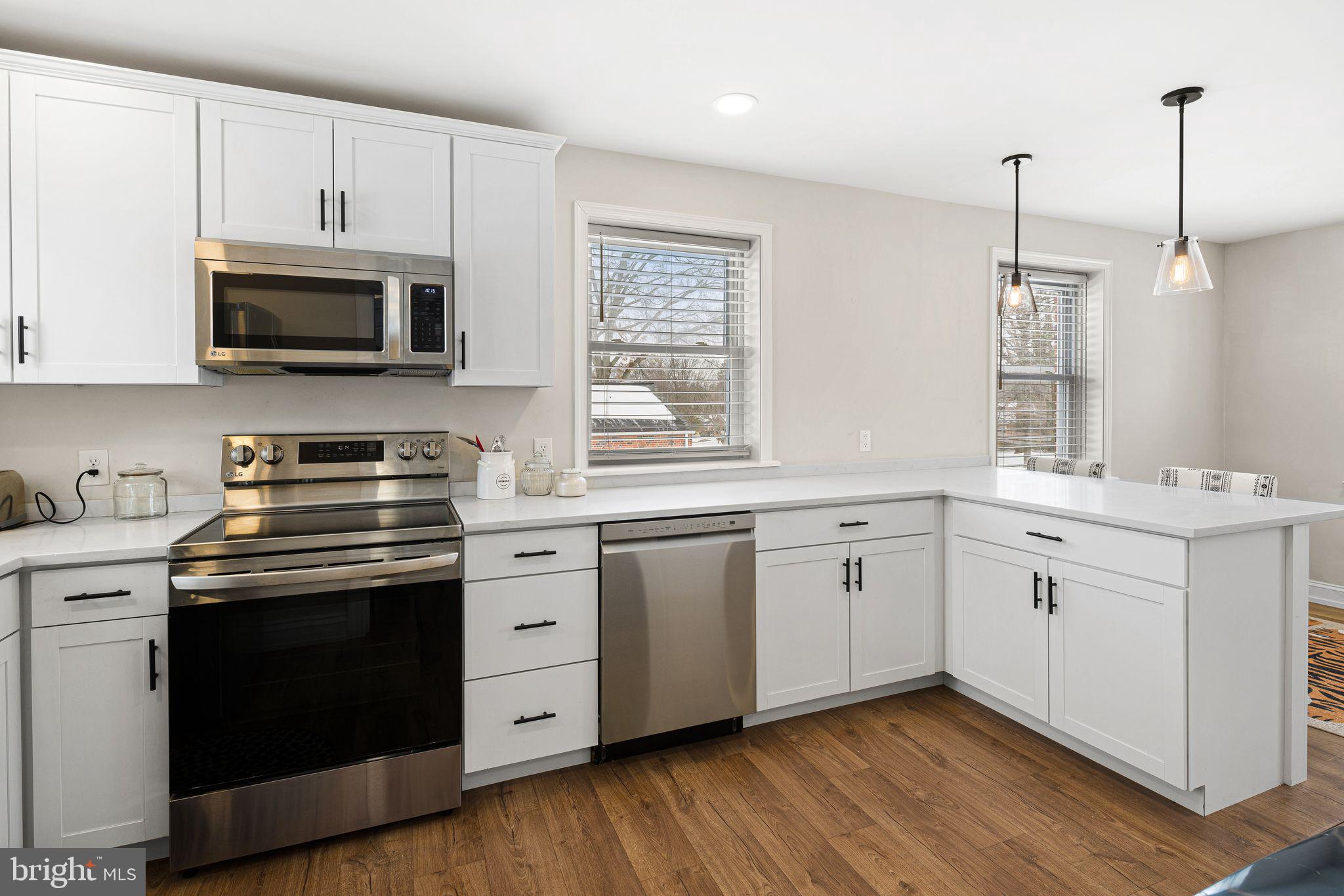 910 Edann Road Oreland, PA 19075 - Photo 9 of 26 a kitchen with white cabinets stainless steel appliances and sink