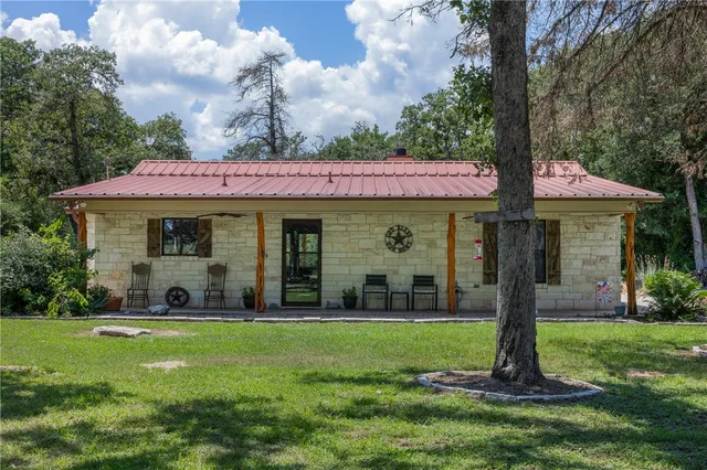 a front view of a house with garden and porch