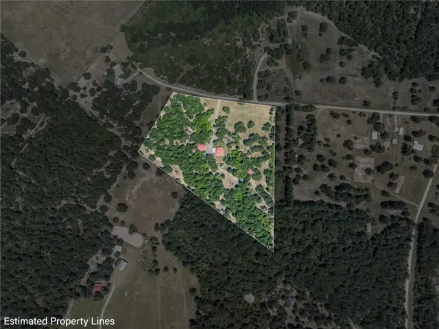 a view of a patio with table and chairs potted plants and large tree