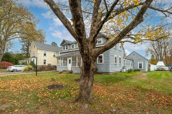 a house that has a tree in front of the house