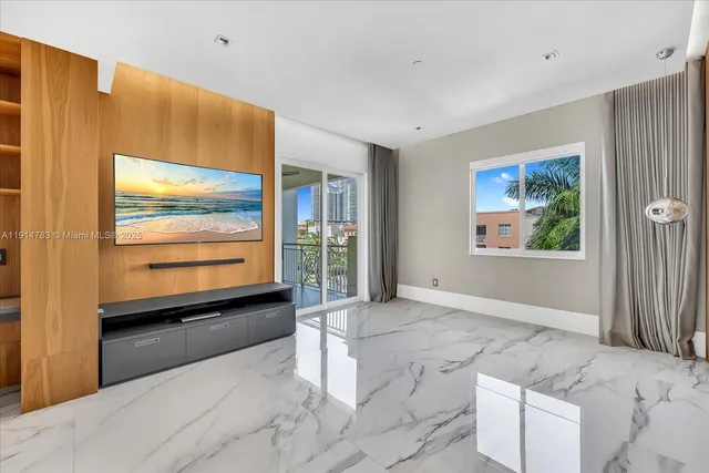 a view of an empty room with a fireplace and a large window