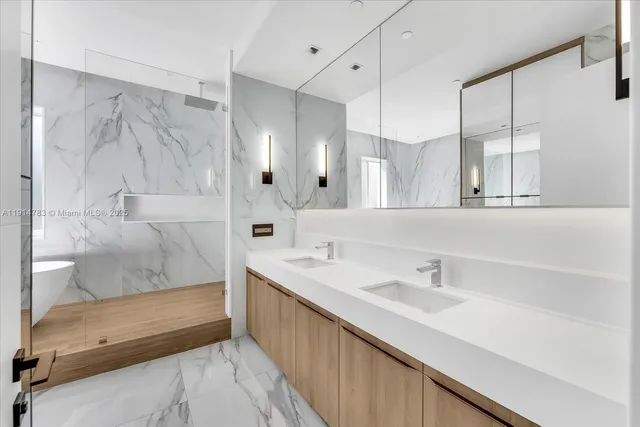 a bathroom with a double vanity sink mirror and shower