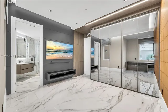 a bedroom with a bed and a view of living room