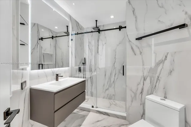 a bathroom with a sink toilet and shower