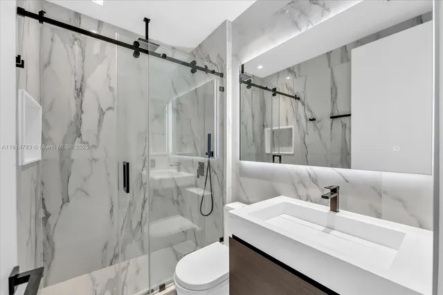 a bathroom with a sink toilet and shower