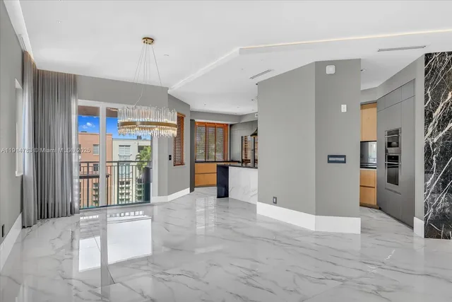 a view of a kitchen with refrigerator and cabinets