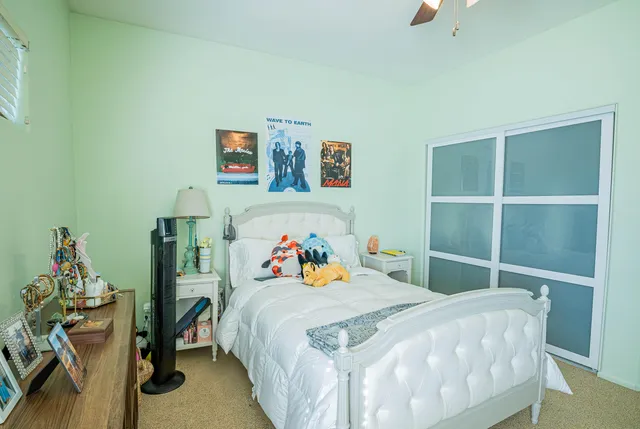 a bedroom with a bed and a chandelier