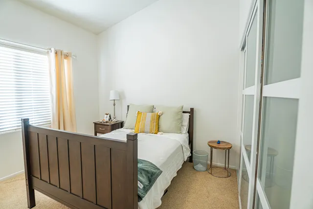 a view of a hallway with wooden shelves