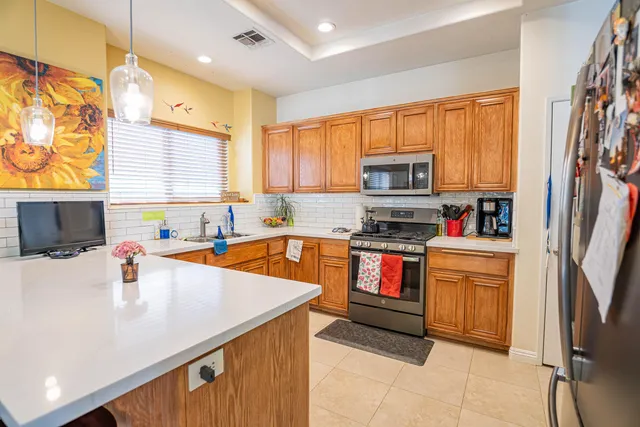 a large kitchen with a table and chairs