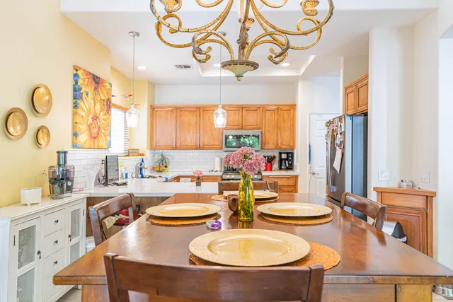 a view of a dining room with furniture and a chandelier