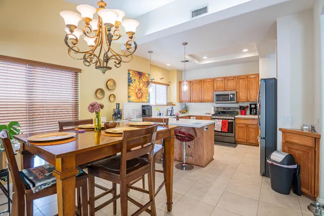 a kitchen with a sink a counter and chairs