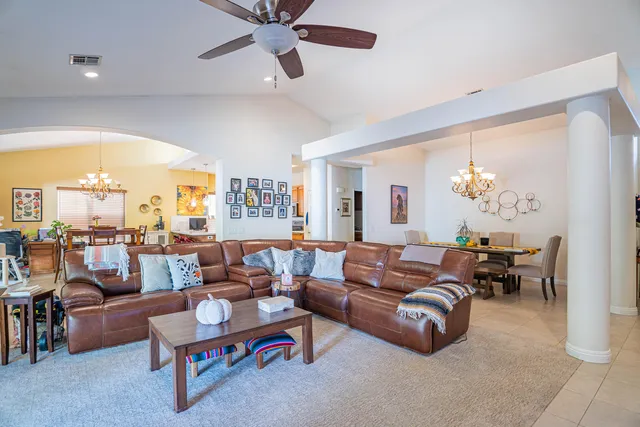 a view of a dining room with furniture a chandelier and wooden floor