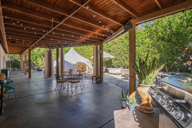 a view of a porch with furniture and a yard