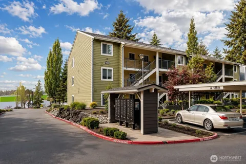 a view of house with outdoor space and parking