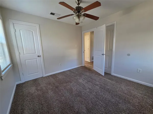 a view of a livingroom with a ceiling fan and window