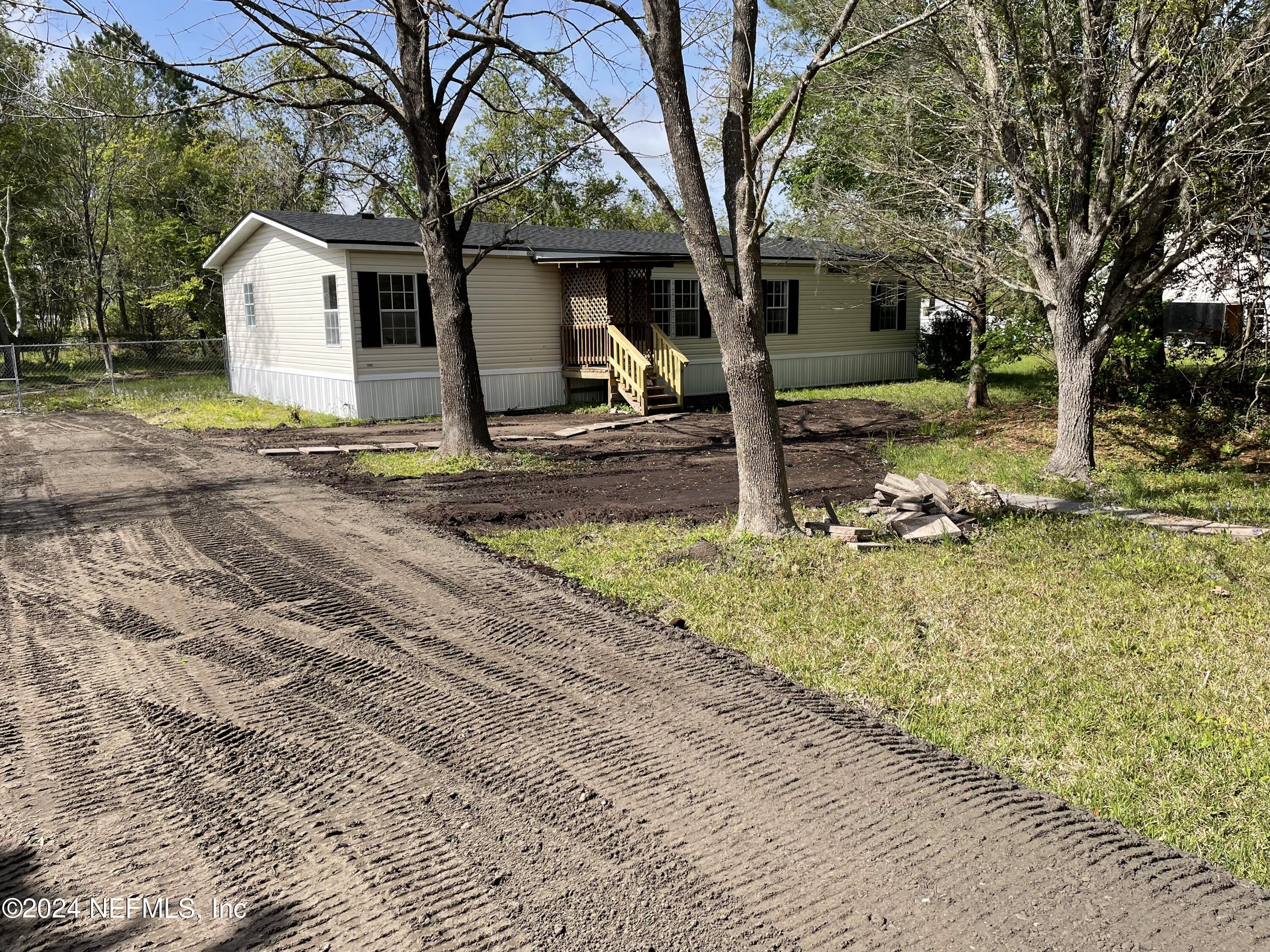 43621 Ratliff Road Callahan, FL 32011 - Photo 3 of 16 a front view of a house with garden