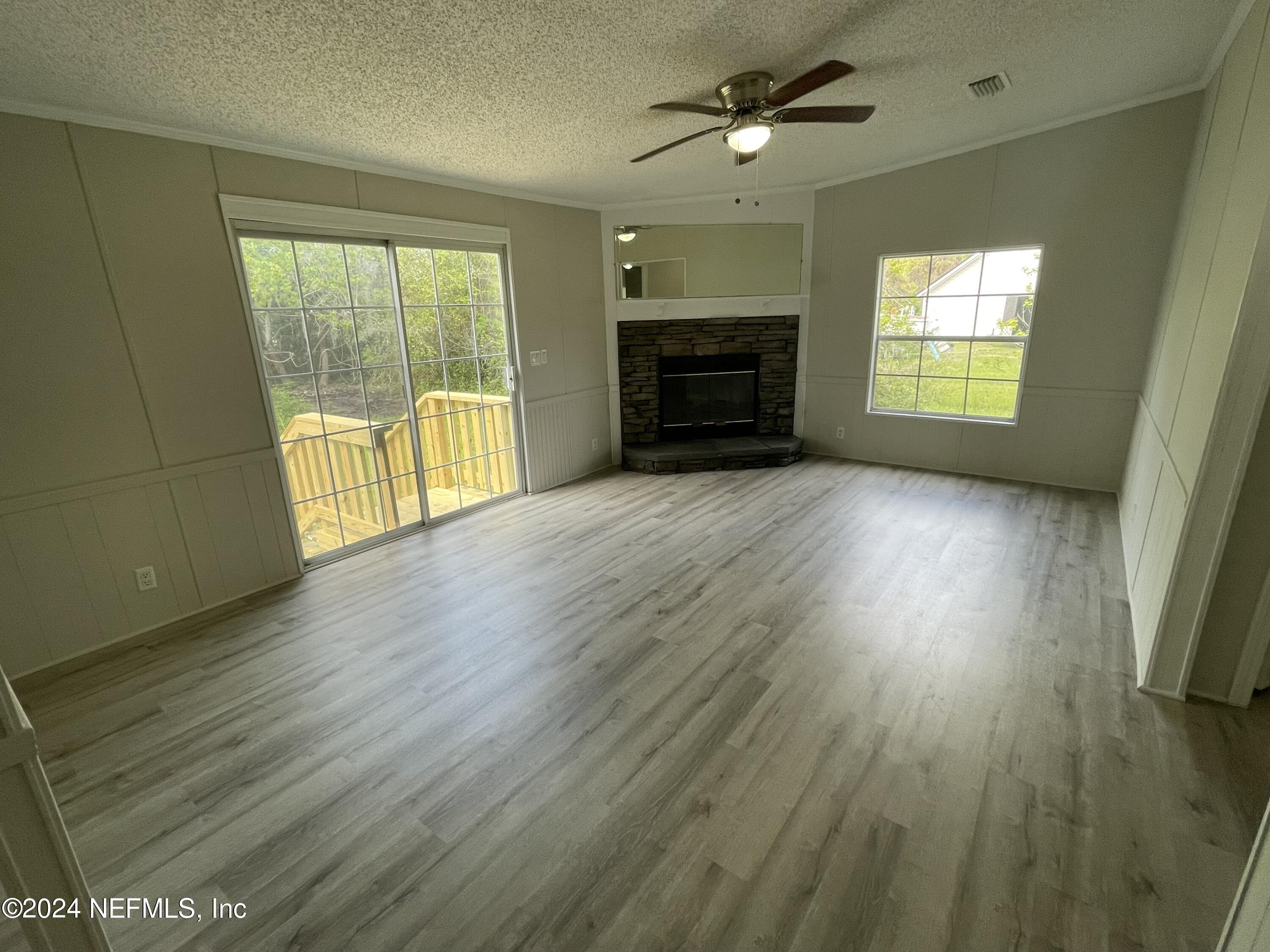 43621 Ratliff Road Callahan, FL 32011 - Photo 7 of 16 wooden floor in an empty room with a window