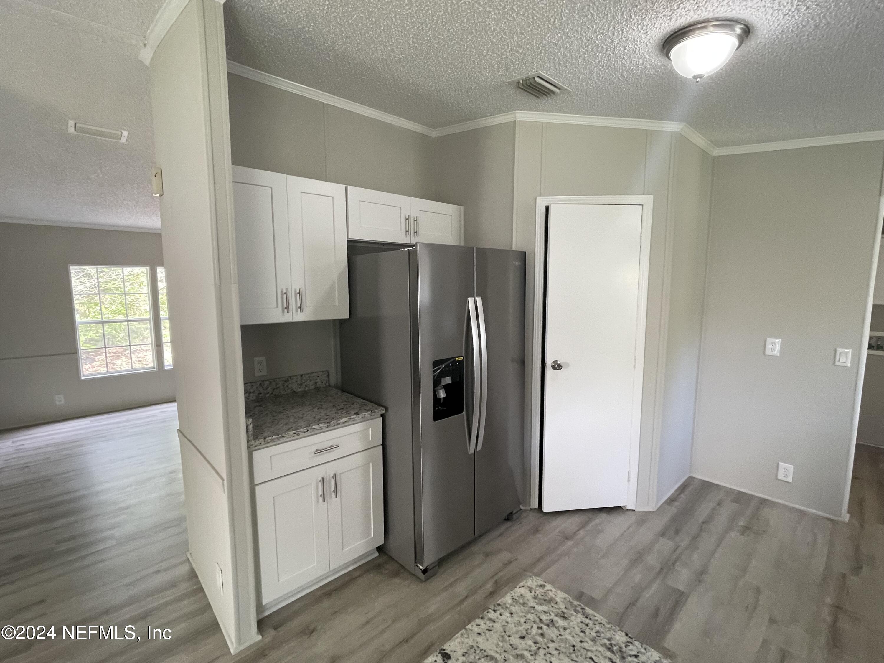 43621 Ratliff Road Callahan, FL 32011 - Photo 10 of 16 a kitchen with a refrigerator and a sink