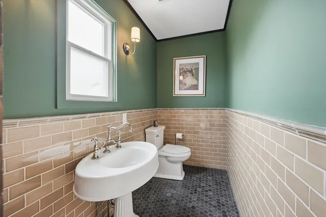 a bathroom with a sink a toilet and mirror