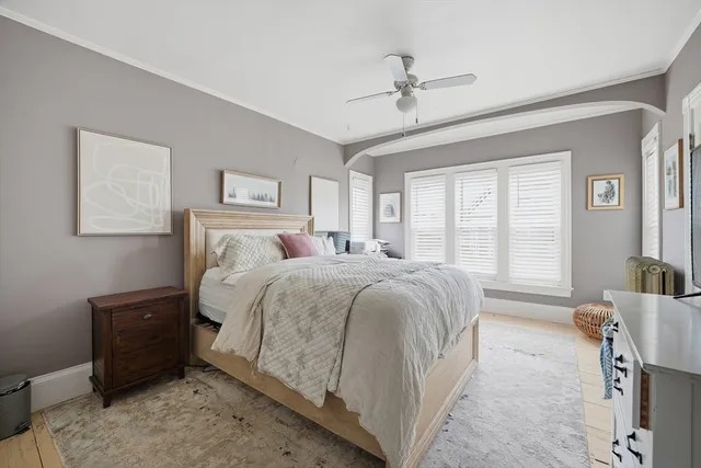 a spacious bedroom with a bed and a chandelier