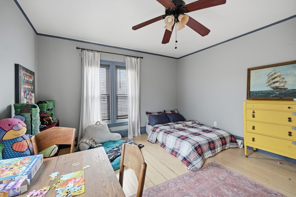 151 Lincoln Street Holyoke, MA 01040 - Photo 27 of 36 a bedroom that has a bed and a chandelier