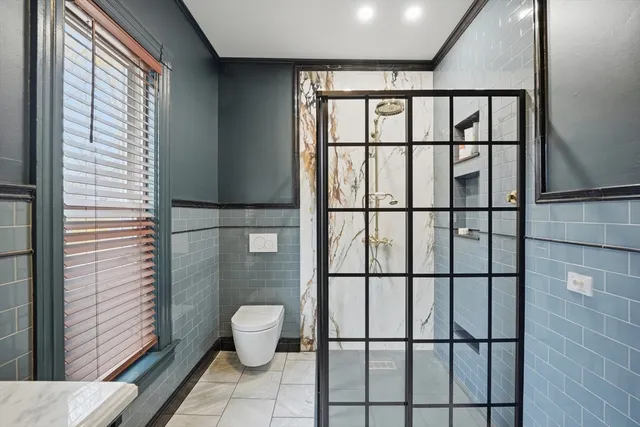 a bathroom with a toilet sink and shower