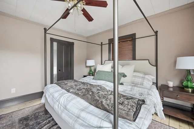 a bedroom with a large bed and a chandelier