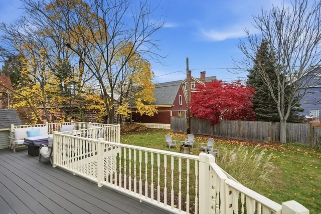 a view of a wooden deck and trees with wooden fence