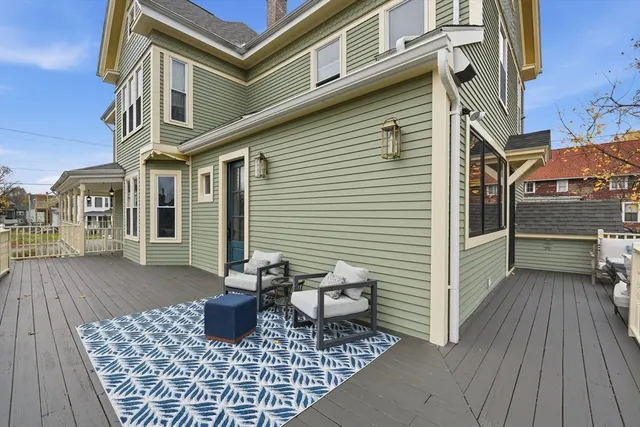 a view of a patio with a table and chairs and wooden floor