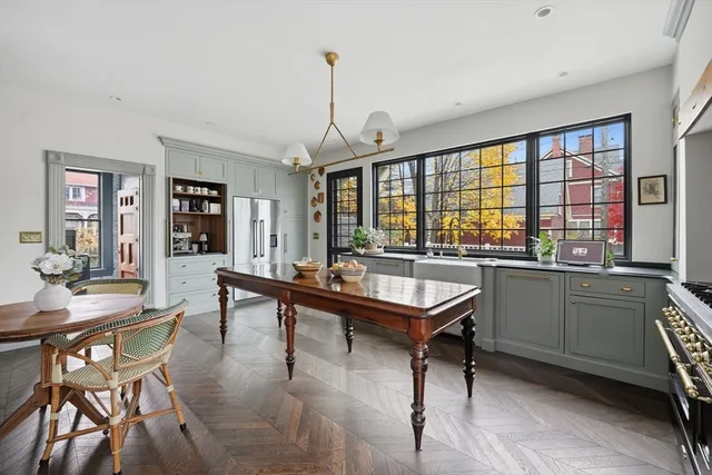 a room with a table chairs and a kitchen view