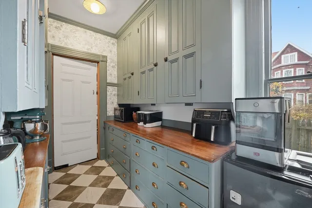 a kitchen with stainless steel appliances granite countertop a sink and a refrigerator