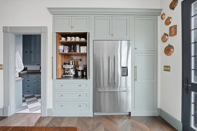 a view of kitchen with refrigerator and window