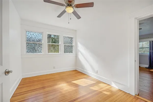 wooden floor in an empty room with a window