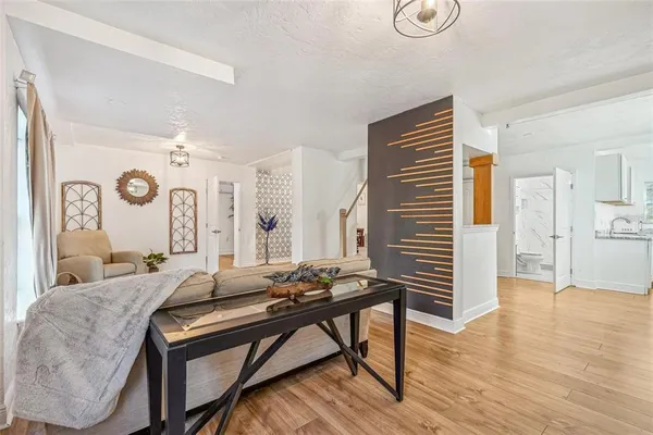 a living room with furniture and wooden floor