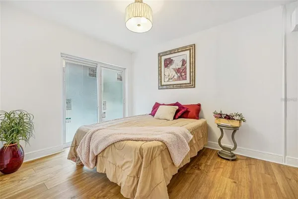 a bedroom with a bed and a painting on the wall