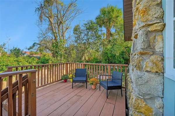 a view of balcony with wooden floor and outdoor seating