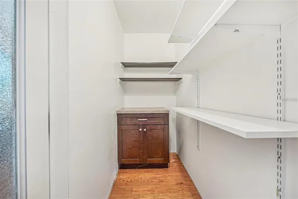 a hallway with closet and wooden floor