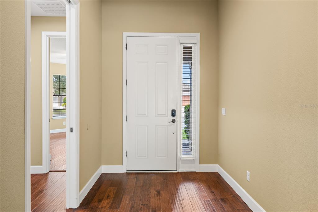 7167 Beek Street Windermere, FL 34786 - Photo 11 of 63 an empty room with wooden floor