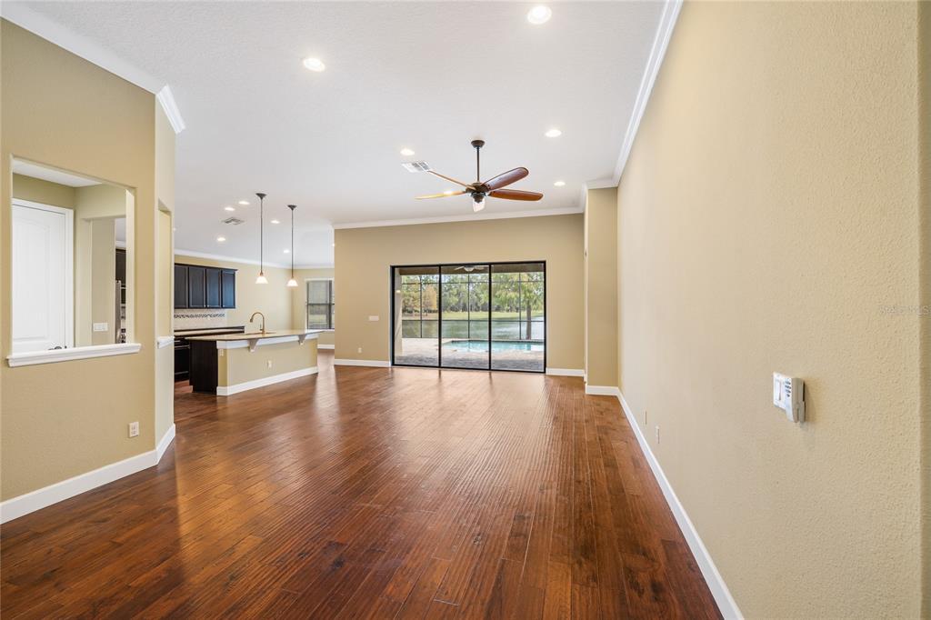 7167 Beek Street Windermere, FL 34786 - Photo 12 of 63 a view of a kitchen with wooden floor and a window