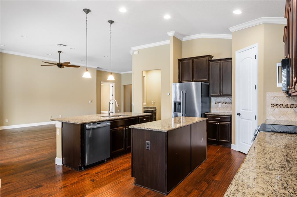 7167 Beek Street Windermere, FL 34786 - Photo 17 of 63 a kitchen with stainless steel appliances granite countertop a sink a stove and refrigerator