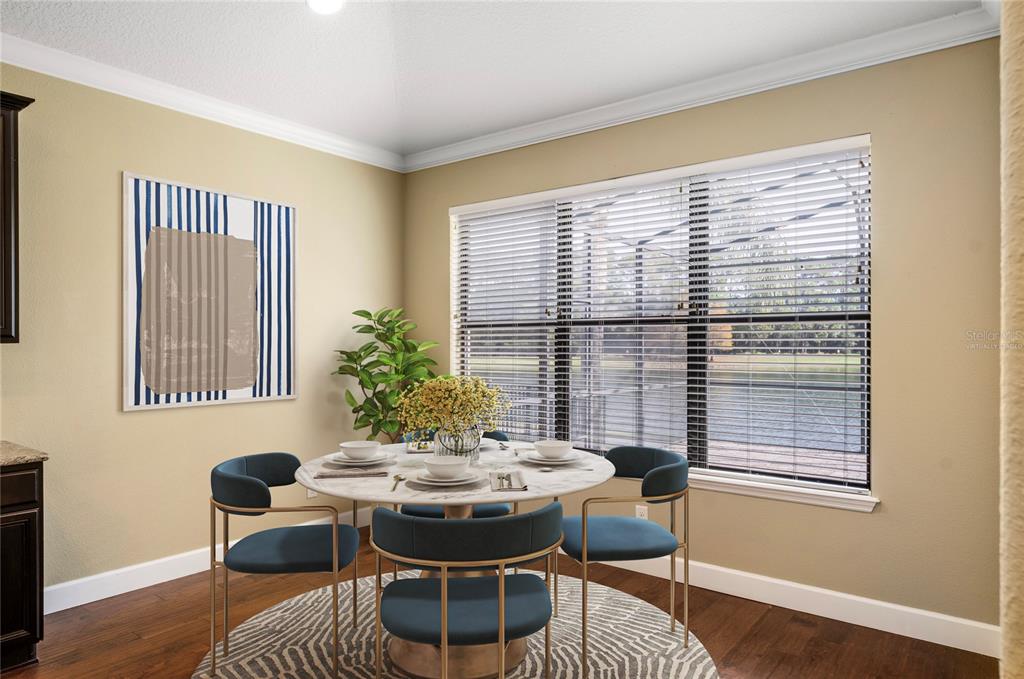 7167 Beek Street Windermere, FL 34786 - Photo 18 of 63 a view of a dining room with furniture and wooden floor