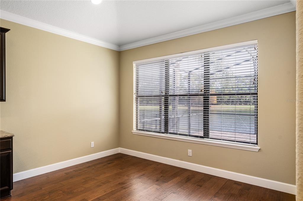 7167 Beek Street Windermere, FL 34786 - Photo 19 of 63 a view of an empty room with wooden floor and a window
