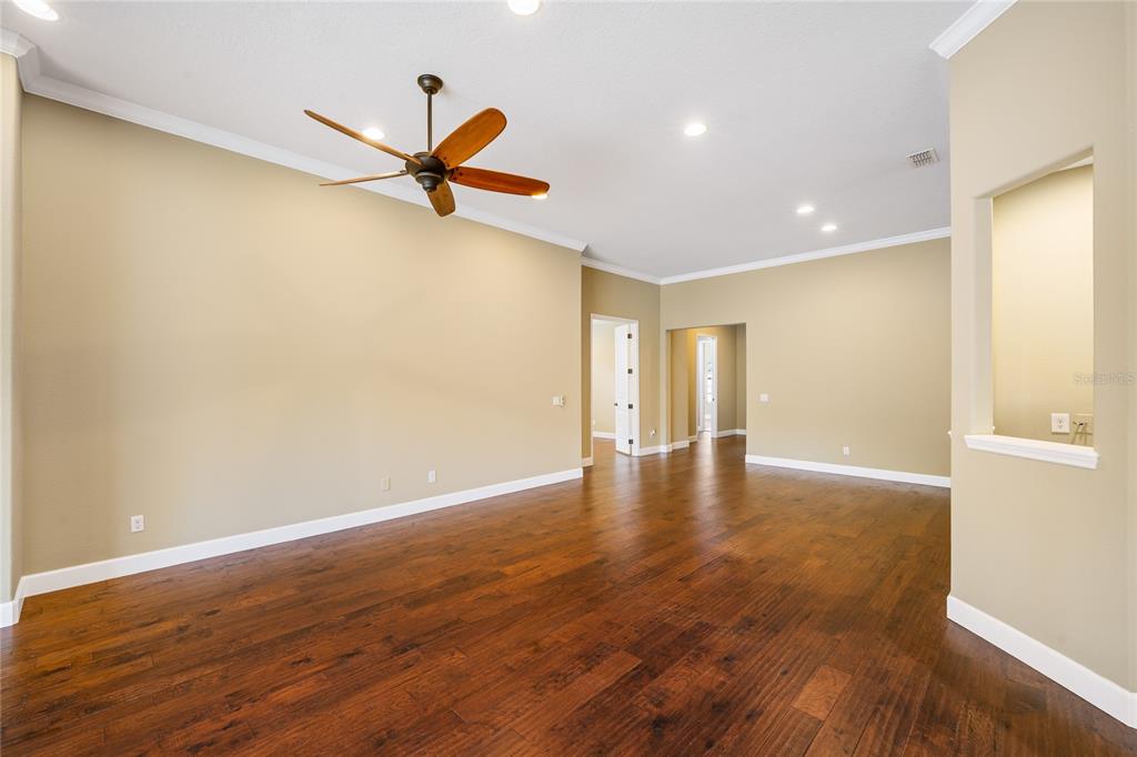 7167 Beek Street Windermere, FL 34786 - Photo 54 of 63 a view of a room with wooden floor and a ceiling fan