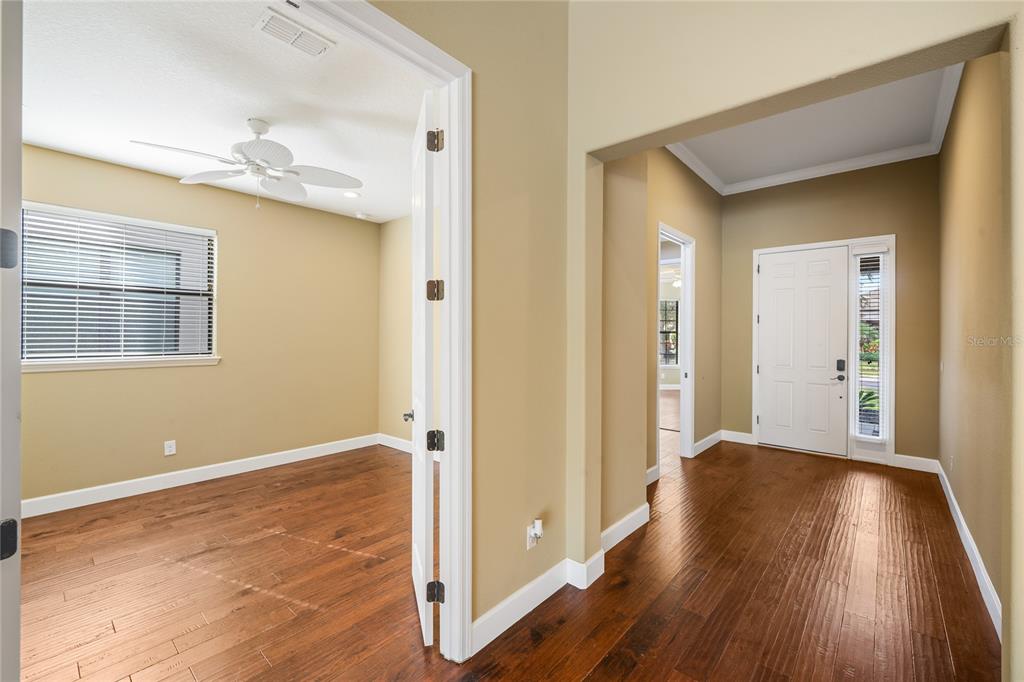 7167 Beek Street Windermere, FL 34786 - Photo 55 of 63 a view of a livingroom with wooden floor and a ceiling fan