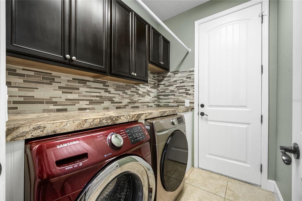 7167 Beek Street Windermere, FL 34786 - Photo 59 of 63 a utility room with dryer and washer