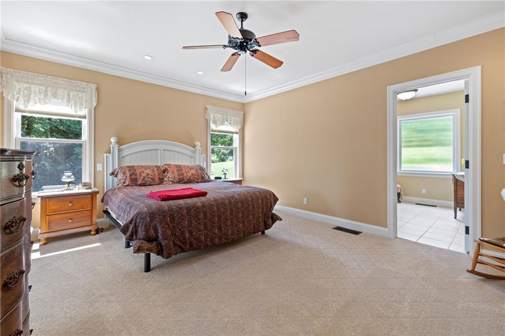 287 Garner Road Edinburg, PA 16116 - Photo 19 of 49 a bedroom with a bed and a walk in closet with wooden floor