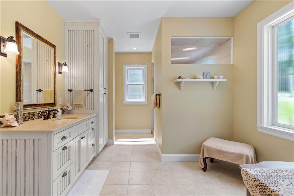 287 Garner Road Edinburg, PA 16116 - Photo 22 of 49 a bathroom with a double vanity sink a mirror and a bathtub