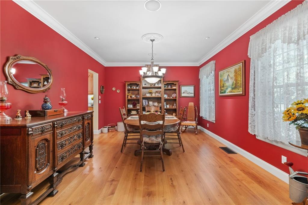 287 Garner Road Edinburg, PA 16116 - Photo 8 of 49 a view of a dining room with furniture a chandelier and wooden floor
