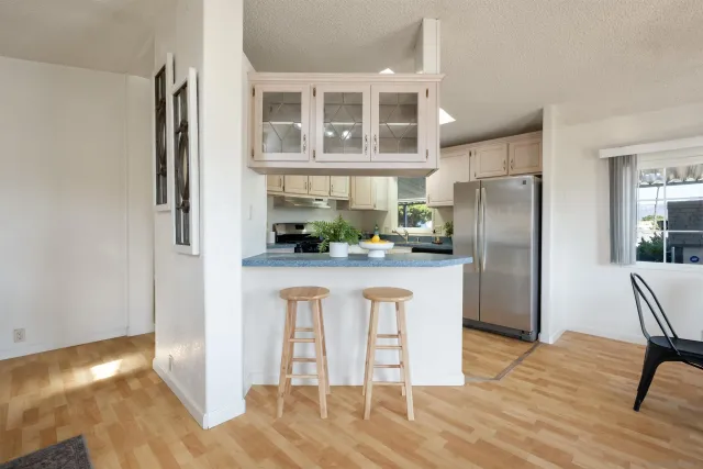 a kitchen with stainless steel appliances a refrigerator and a stove