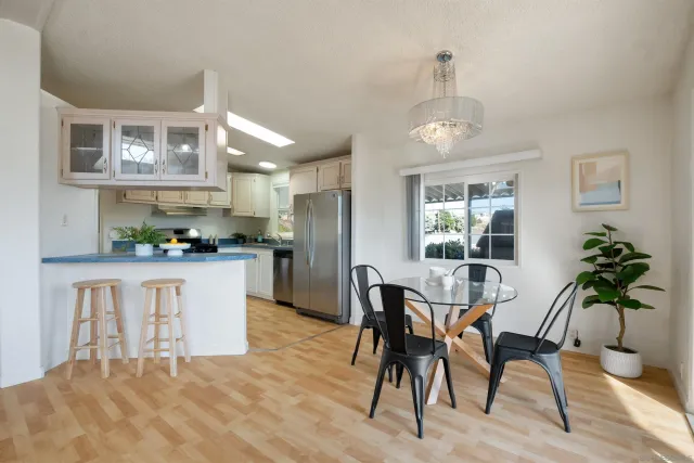 a kitchen with granite countertop white cabinets and stainless steel appliances